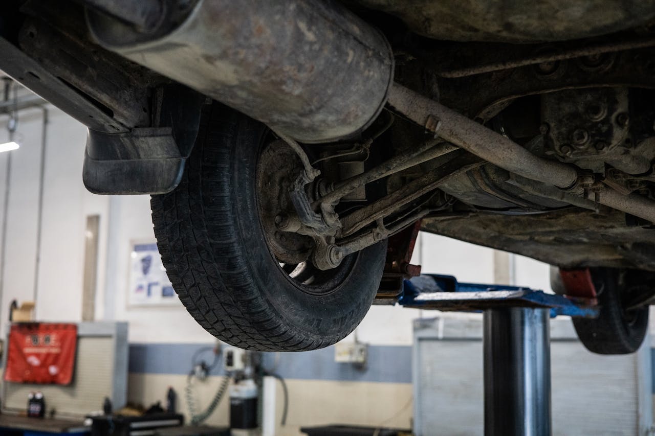 Close-up of cars undercarriage in a service station for repair and maintenance.